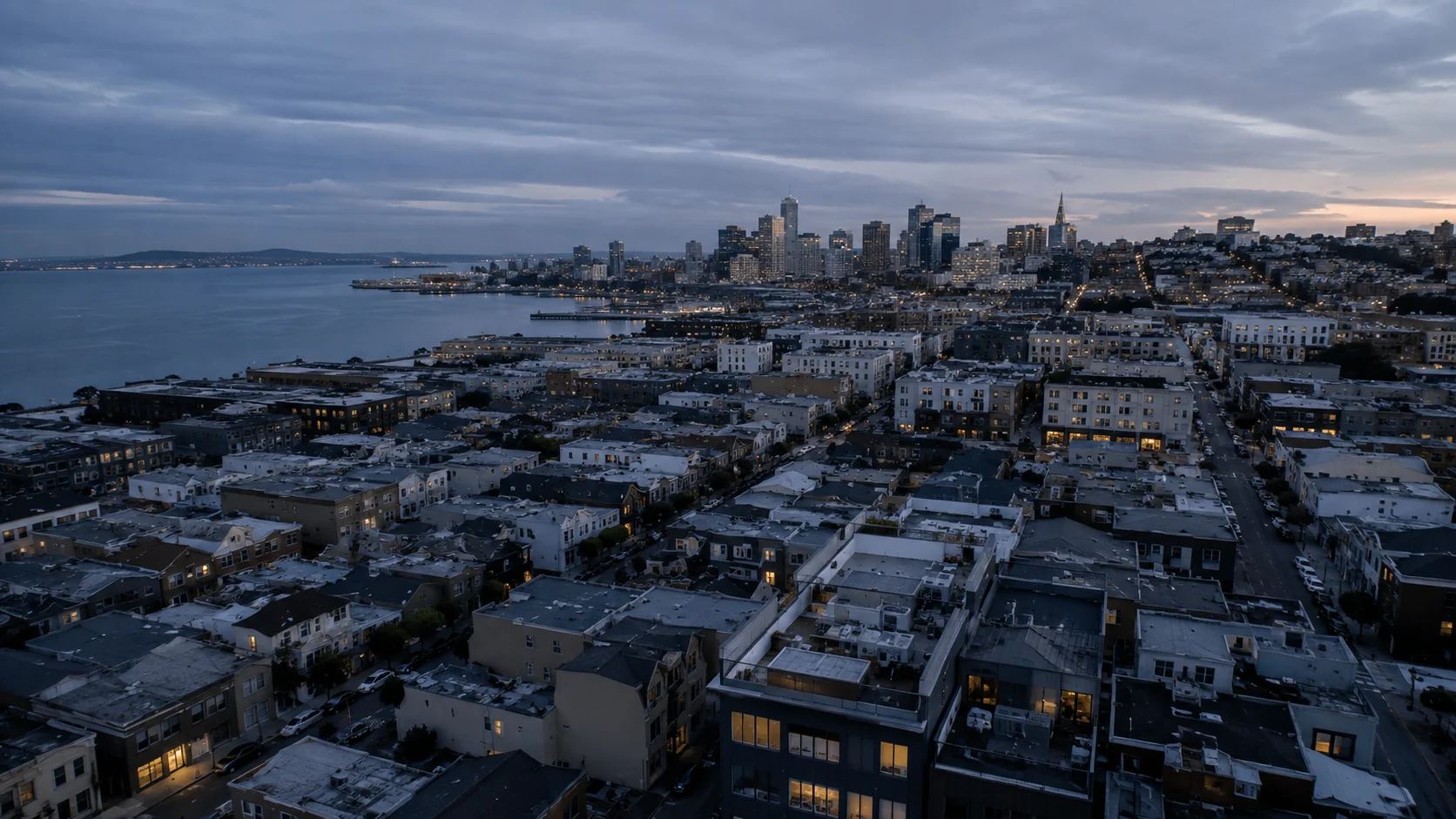An aerial view of waterfront residential neighborhoods at dusk